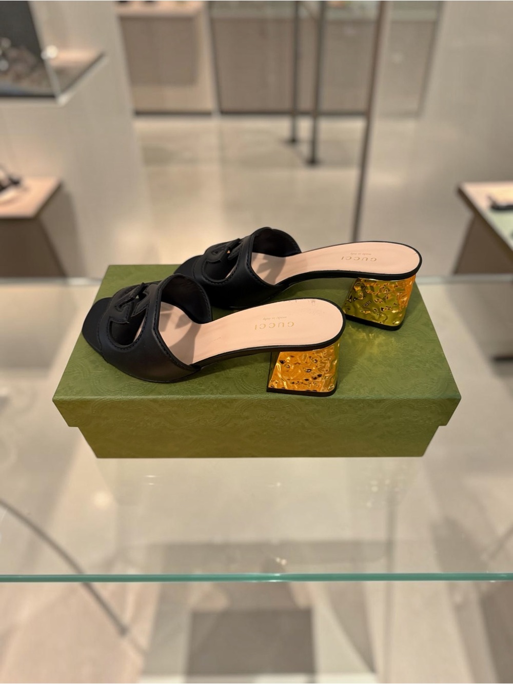 Gucci Interlocking G Cut Out Black Leather Mules with Gold Textured Block Heel